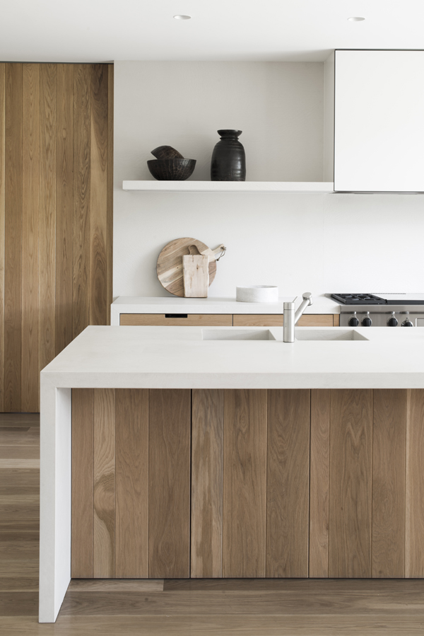 simple contemporary kitchen. white worktops, wooden cabinets