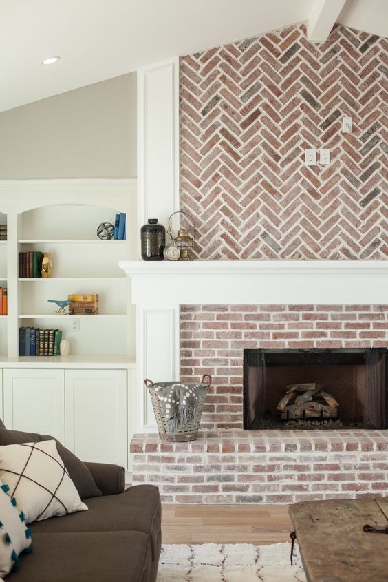 Fireplace with herringbone pattern brick work and built in shelving - by Rafterhouse.: 