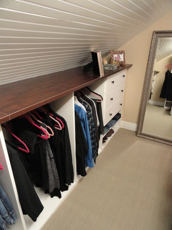 attic closet with hangers and drawers