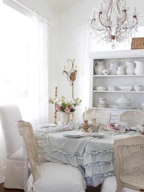 a crystal chandelier and a serenity ruffled tablecloth create an ambience