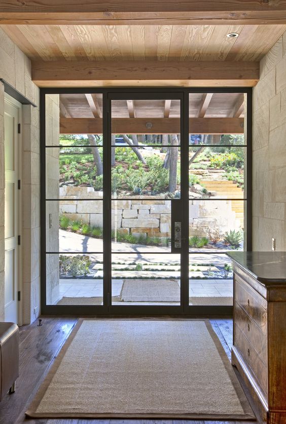 glass and steel front door for blending outdoors and indoors