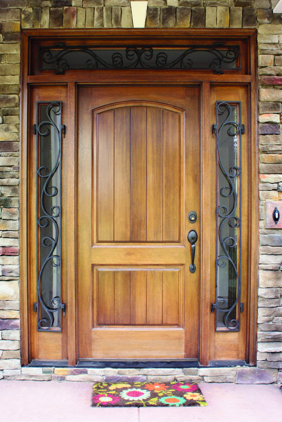 tan front door with forged sidelights