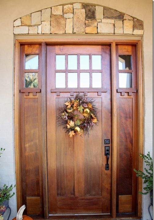 modern stained wood door with sidelights