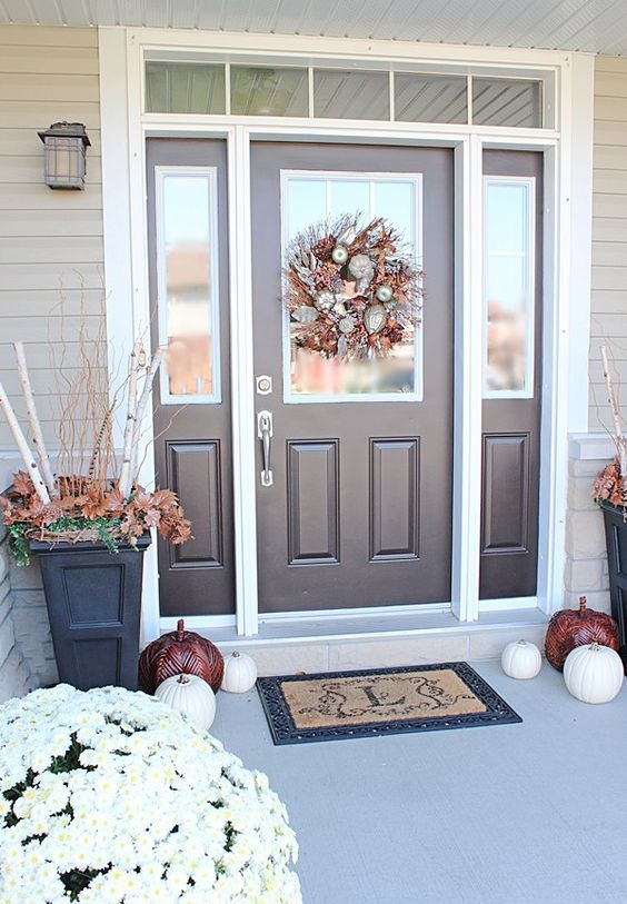 brown door and sidelights framed in white