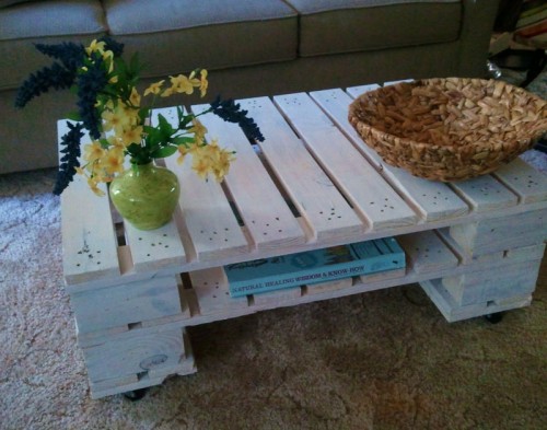 DIY whitewashed pallet coffee table with a storage shelf