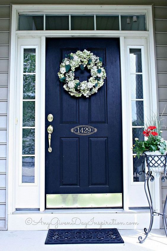 black weathered door with white sidelights