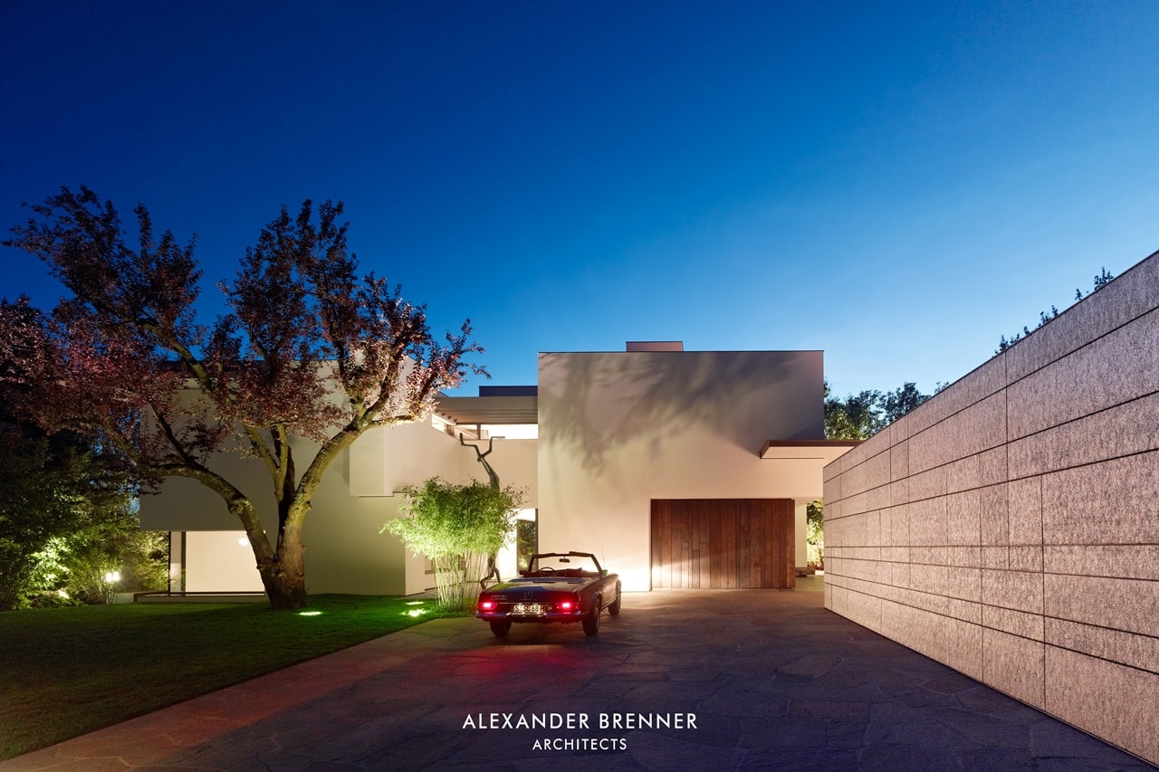 Driveway of modern villa by Alexander Brenner at night