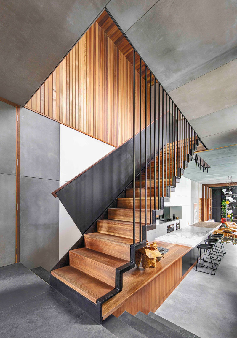 The steel and wood stairs in this modern house lead to the upper floor of the home that houses the bedrooms.