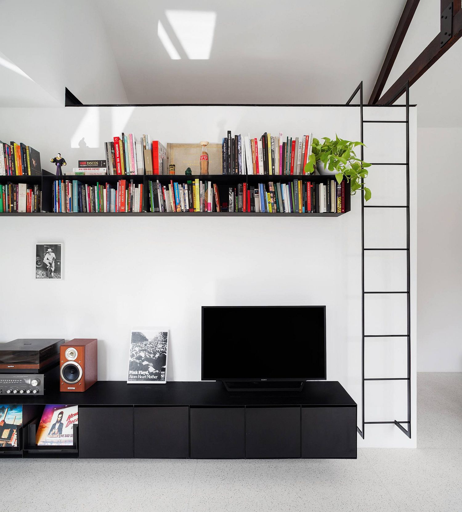 Metallic space-savvy shelving in a white ultra-small apartment