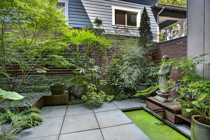 Asian style patio with concrete and horizontal wood fence