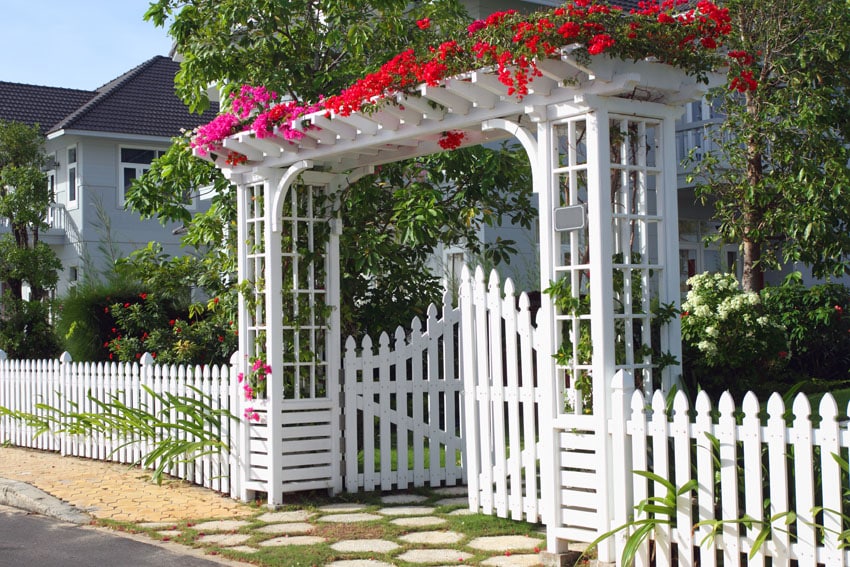 Beautiful white garden fence with gated pergola