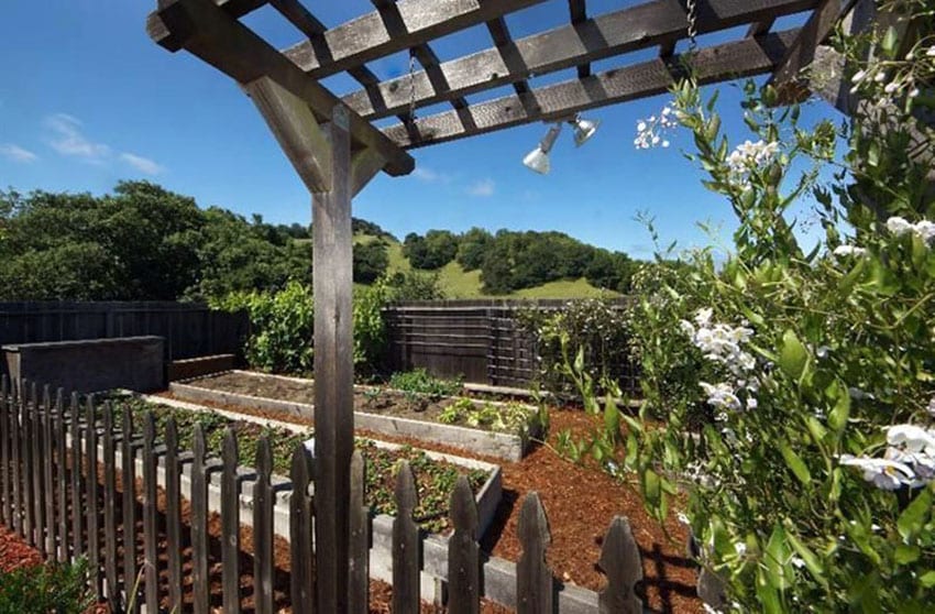 Wood garden fence with small pergola