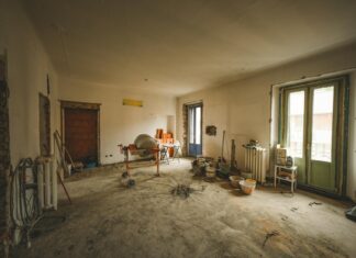 8 Home Renovation Ideas That Add Real Value to Your Property in 2026 Wide view of a sunny room under renovation with construction materials and tools present, ideal for home improvement concepts.