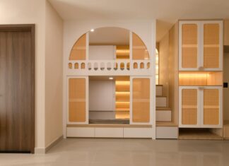 9 Smart Storage Solutions That Will Transform Your Small Space in 2026 Stylish minimalist interior with integrated storage solutions and warm lighting.
