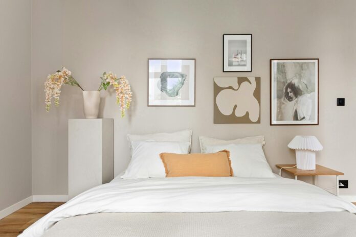 Elegant minimalist bedroom with modern artwork and decor, exuding calmness.