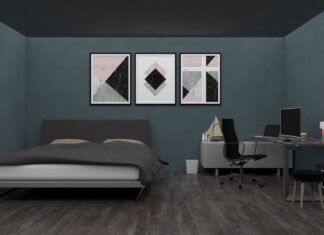 7 Interior Design Principles That Will Instantly Elevate Every Room in Your Home Stylish bedroom with a desk, modern art, and gray walls featuring minimalist design elements.