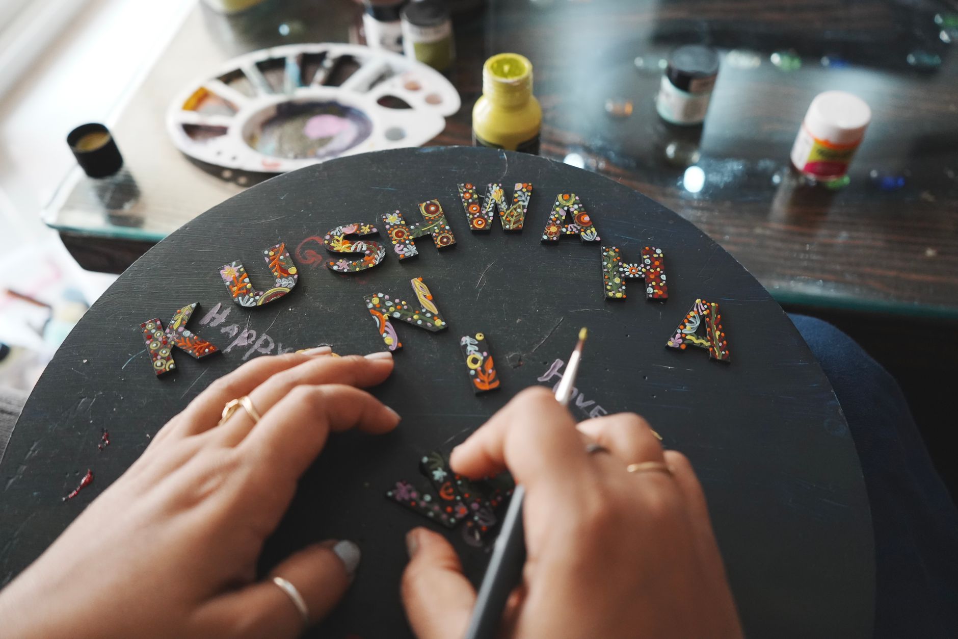 Colorful handcrafted letters being painted for DIY wall decor