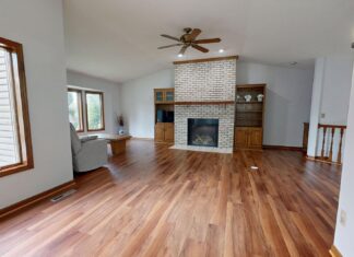 10 Living Room Renovation Ideas That Will Completely Transform Your Space Modern living room with wooden floors and brick fireplace.