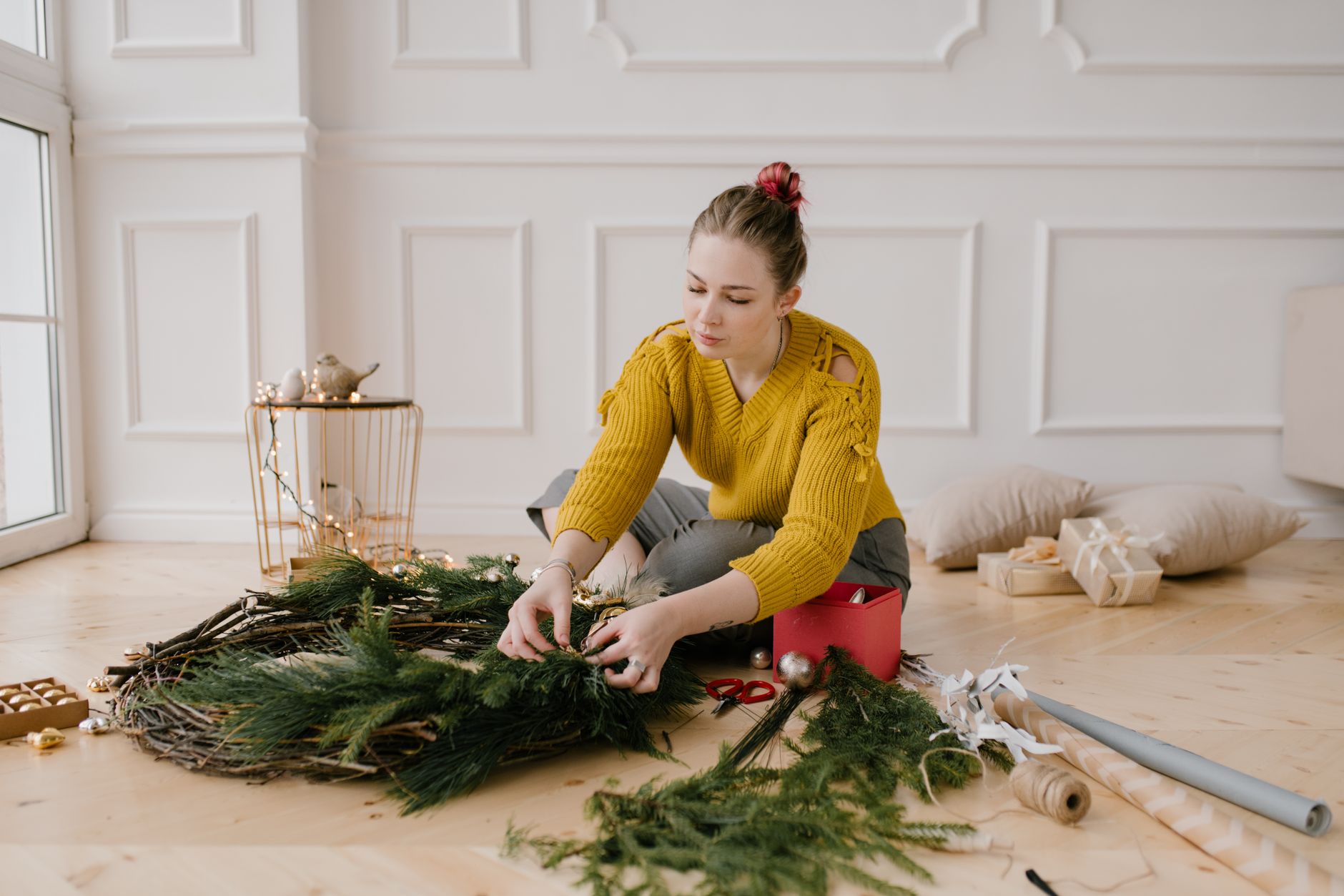 Woman decorating a wreath inside a cozy home craft room