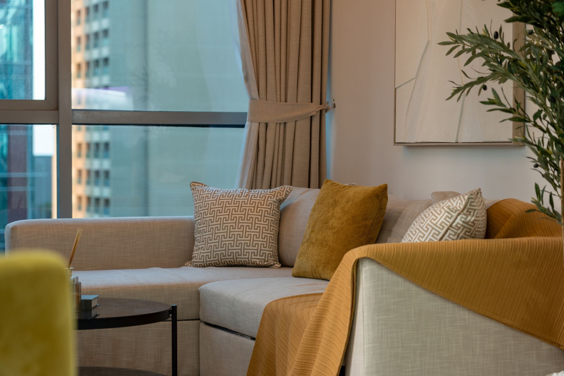 Elegant modern living room in Dubai featuring a cozy sofa and stylish decor.