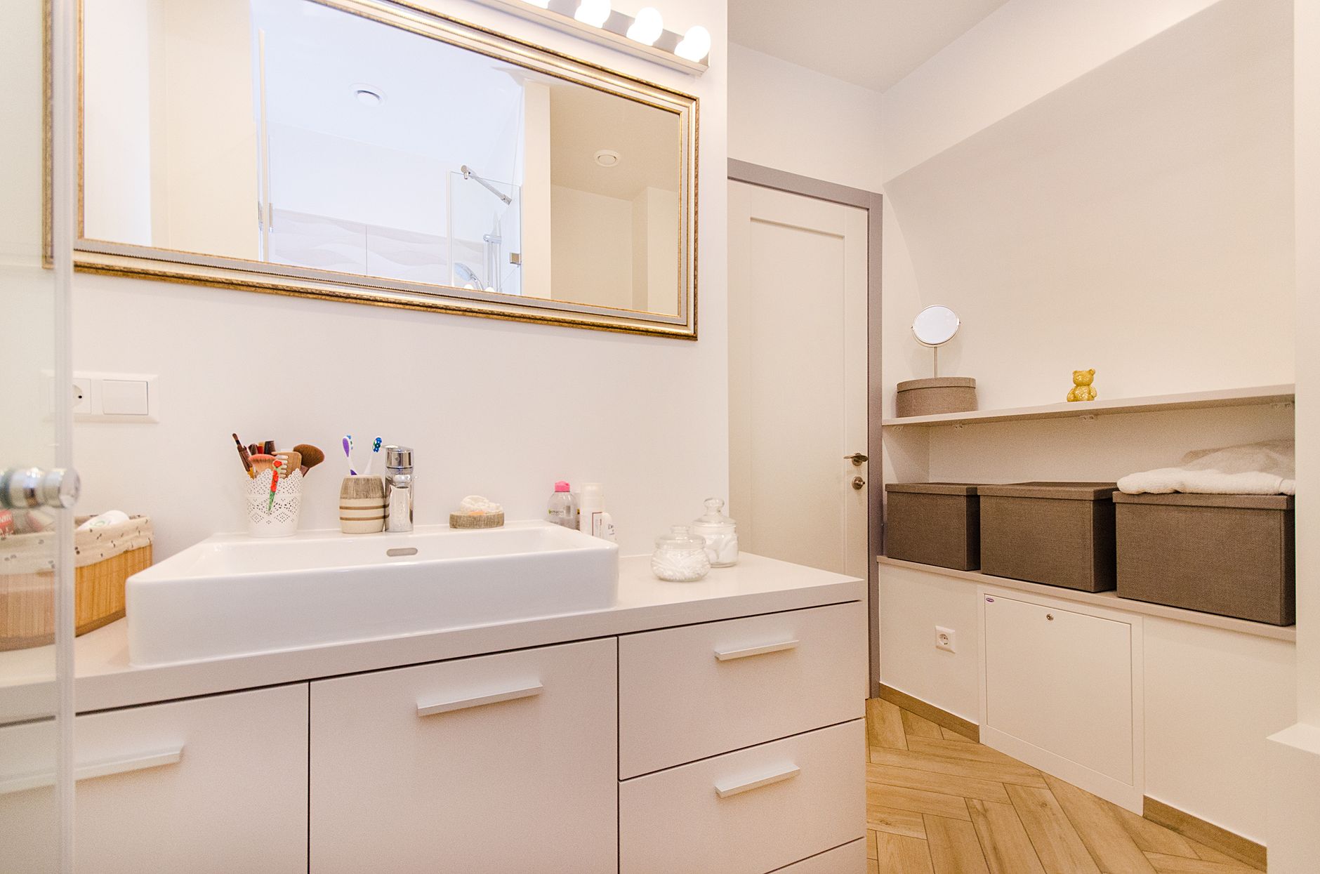 Organized bathroom storage with neatly arranged baskets, towels, and toiletries.