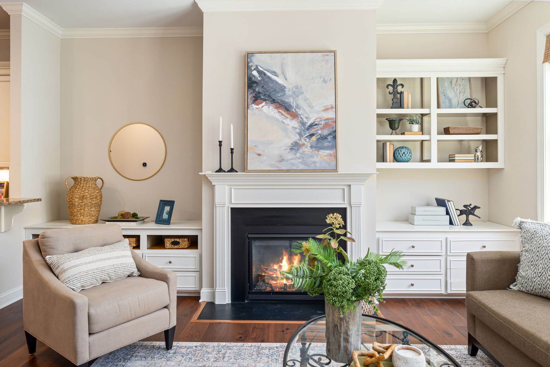 Elegant living room featuring a modern fireplace, art, and stylish furniture for a cozy ambiance.