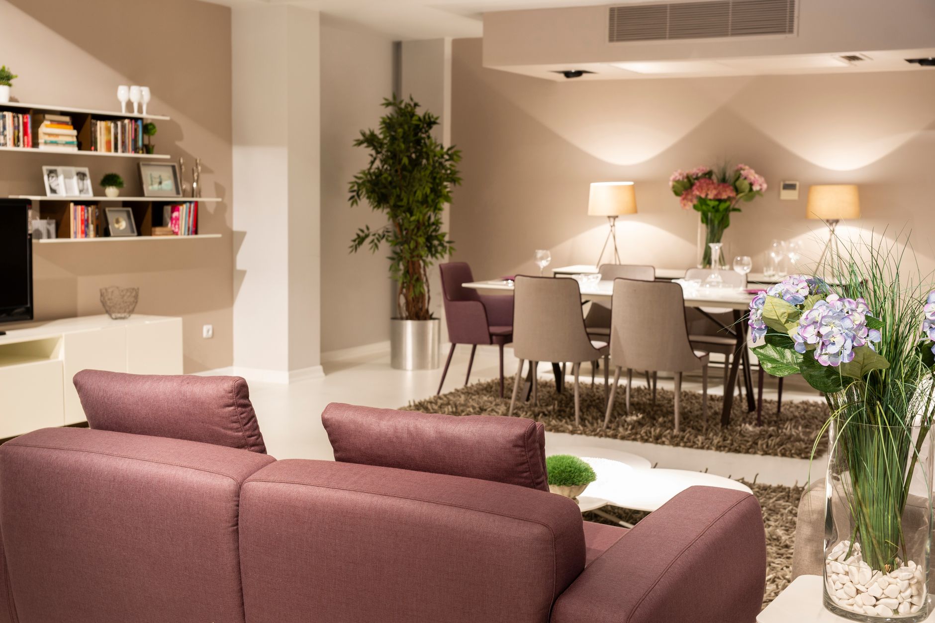 Stylish living and dining area with contemporary decor and cozy lighting.