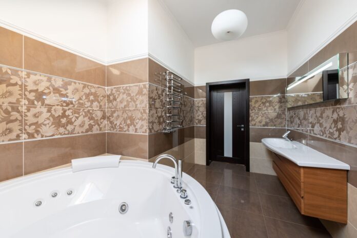 pexels-6957081 Interior of contemporary bathroom with round ceramic bathtub and sink and wooden cabinet in daytime