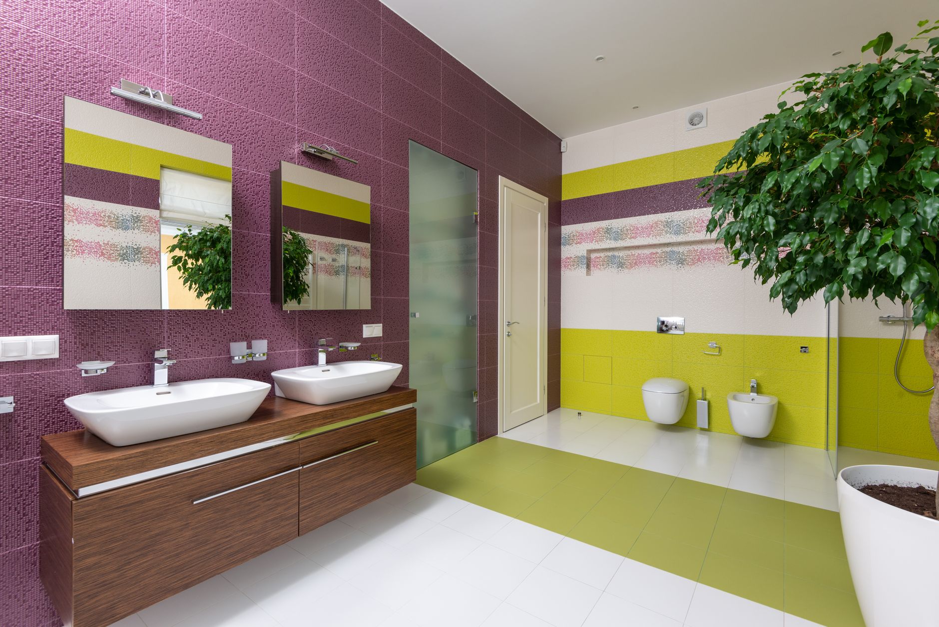 Interior of modern master bathroom with glass shower cabin and double sink cabinet with mirrors on wall