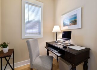 9 Small Space Home Office Ideas for Style and Productivity A tidy home office space with a wooden desk, laptop, and ambient lighting. Perfect for remote work.
