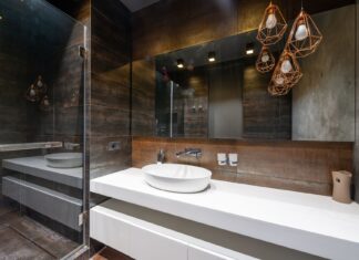 9 Bathroom Mirror Ideas That Instantly Elevate Your Space A sleek modern bathroom featuring pendant lighting and a contemporary sink.