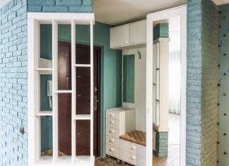 9 Small Entryway Ideas That Make a Big First Impression Stylish modern entryway with white shelving and brick walls in a home interior.