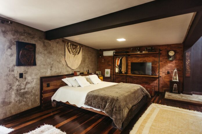 Stylish bedroom interior in Santa Teresa, Brazil featuring modern decor and warm tones.