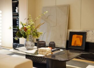8 Unexpected Places to Find Decorating Inspiration for Your Home A stylish modern interior with a marble table featuring a decorative flower vase and artwork.