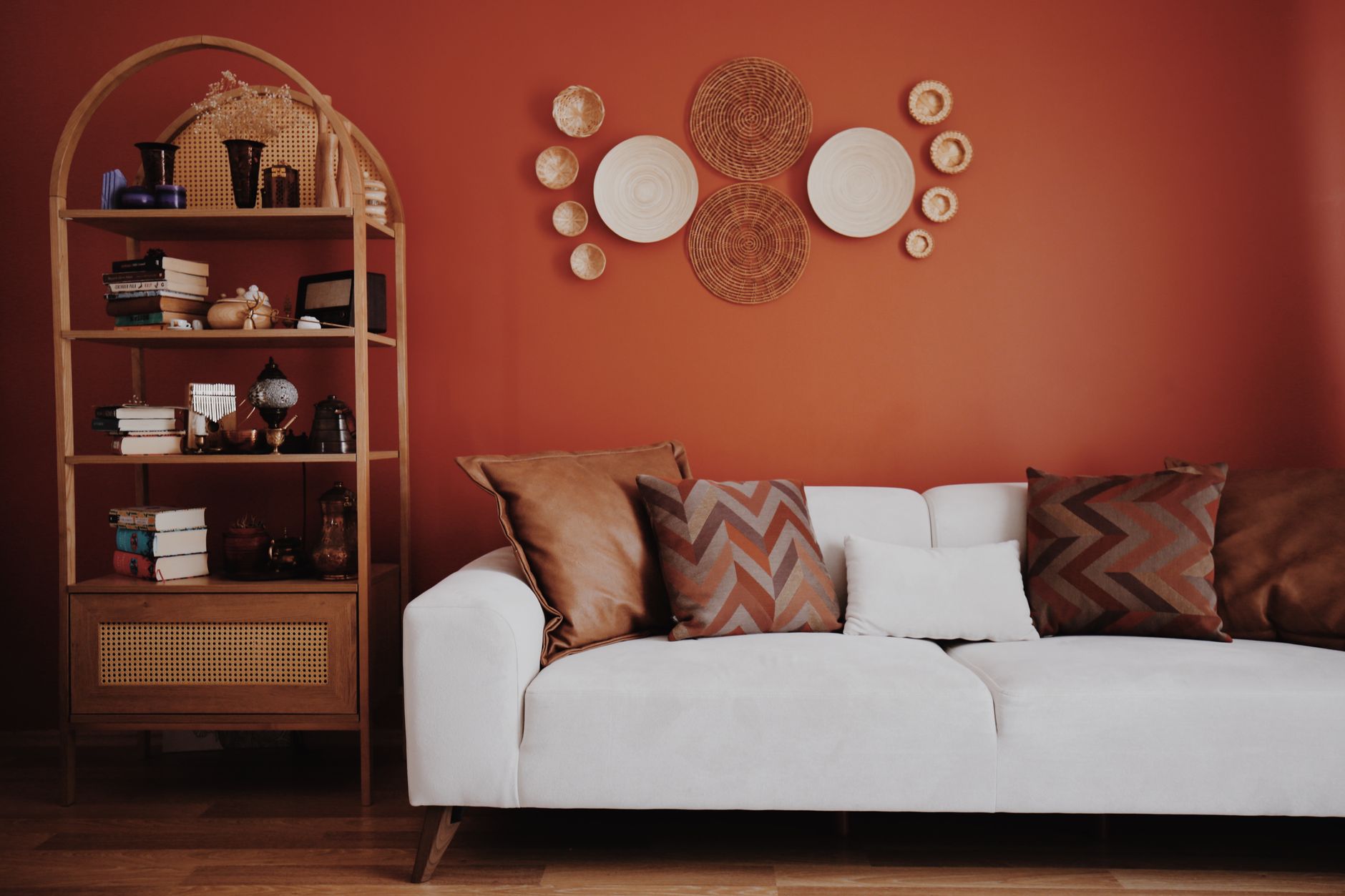 Elegant living room featuring a modern couch, decorative wall art, and an organized bookshelf.
