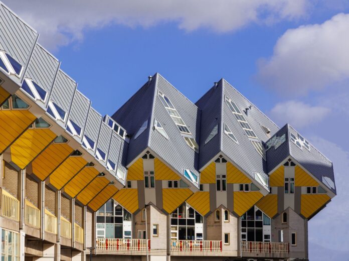 Capture of the iconic Cube Houses in Rotterdam with blue sky backdrop, showcasing unique modern architecture.
