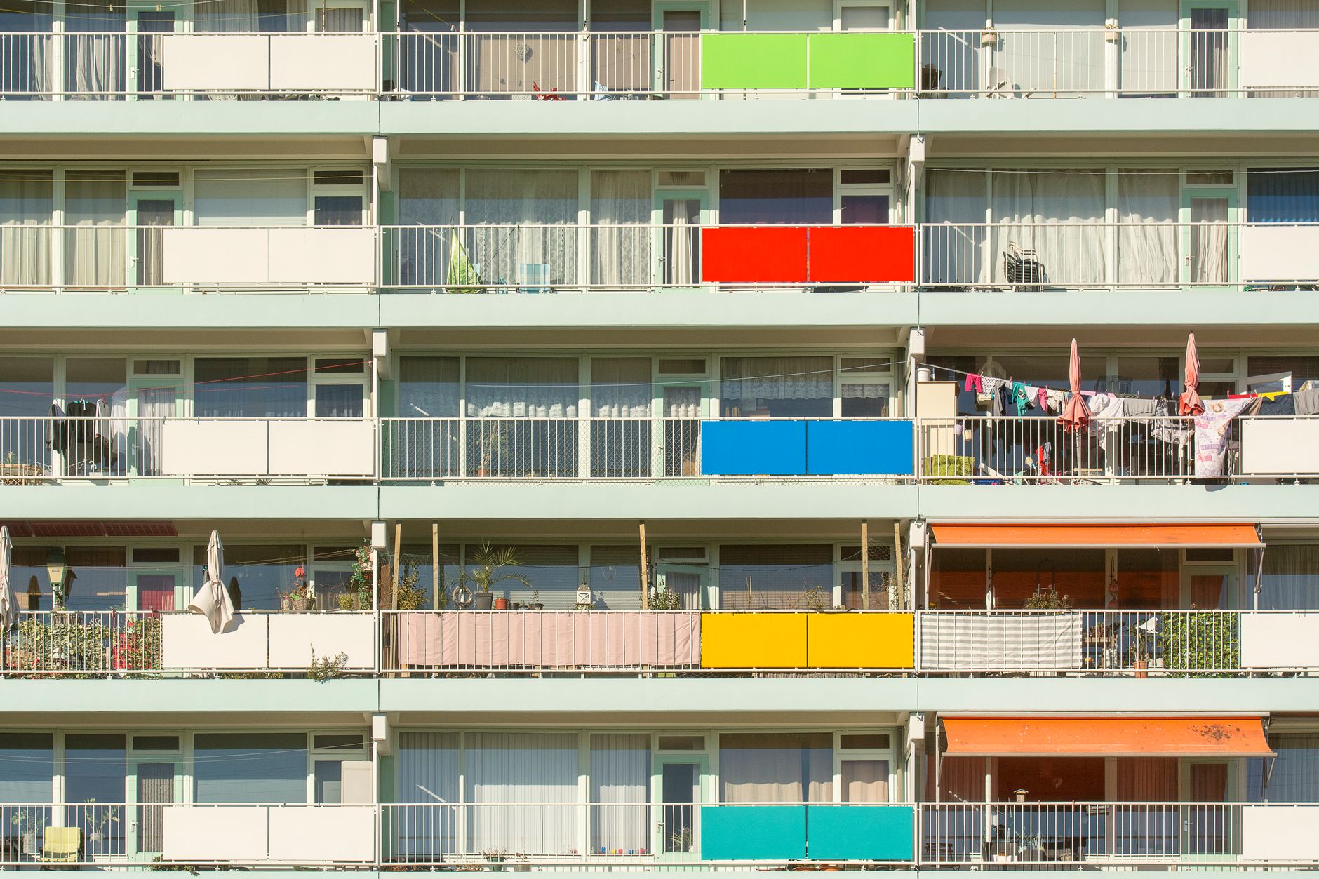 A vibrant display of colorful balconies on a residential building. Perfect for urban lifestyle themes.