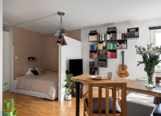 9 Multi-Functional Furniture Ideas That Make Small Spaces Work Smarter A stylish studio apartment with a cozy bed, bookshelf, and modern decor.