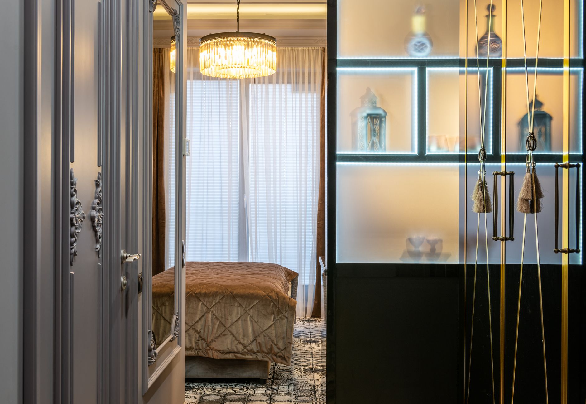 Open door in house room with assorted lanterns on shelfs and hanging tassels against glowing light