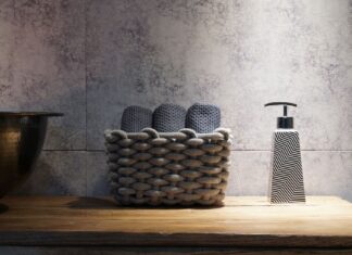 9 Bathroom Accessory Ideas That Add Style and Function Stylish bathroom setup featuring a woven basket and a contemporary soap dispenser on a wooden countertop.