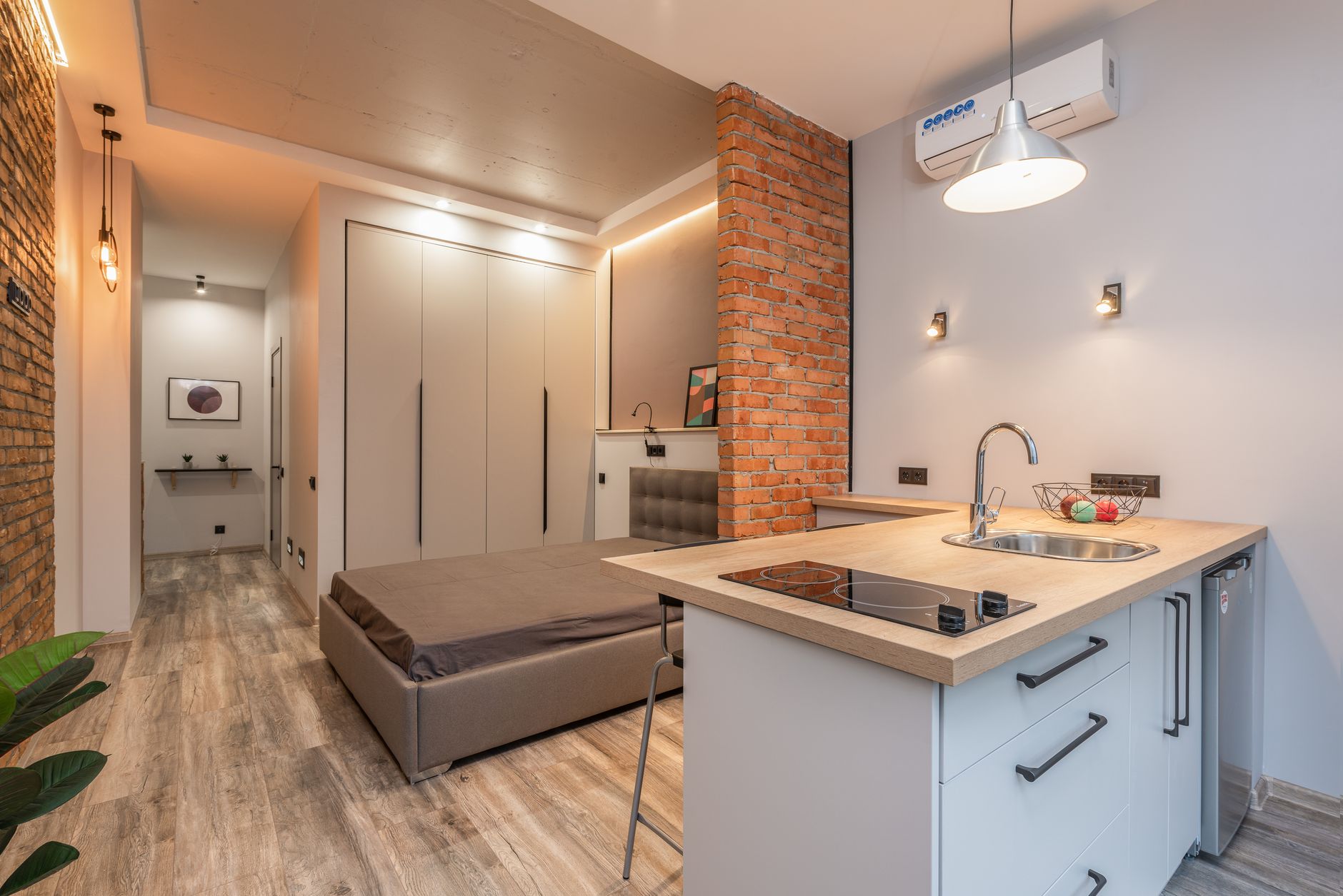 Bright small space interior with warm layered lighting design.