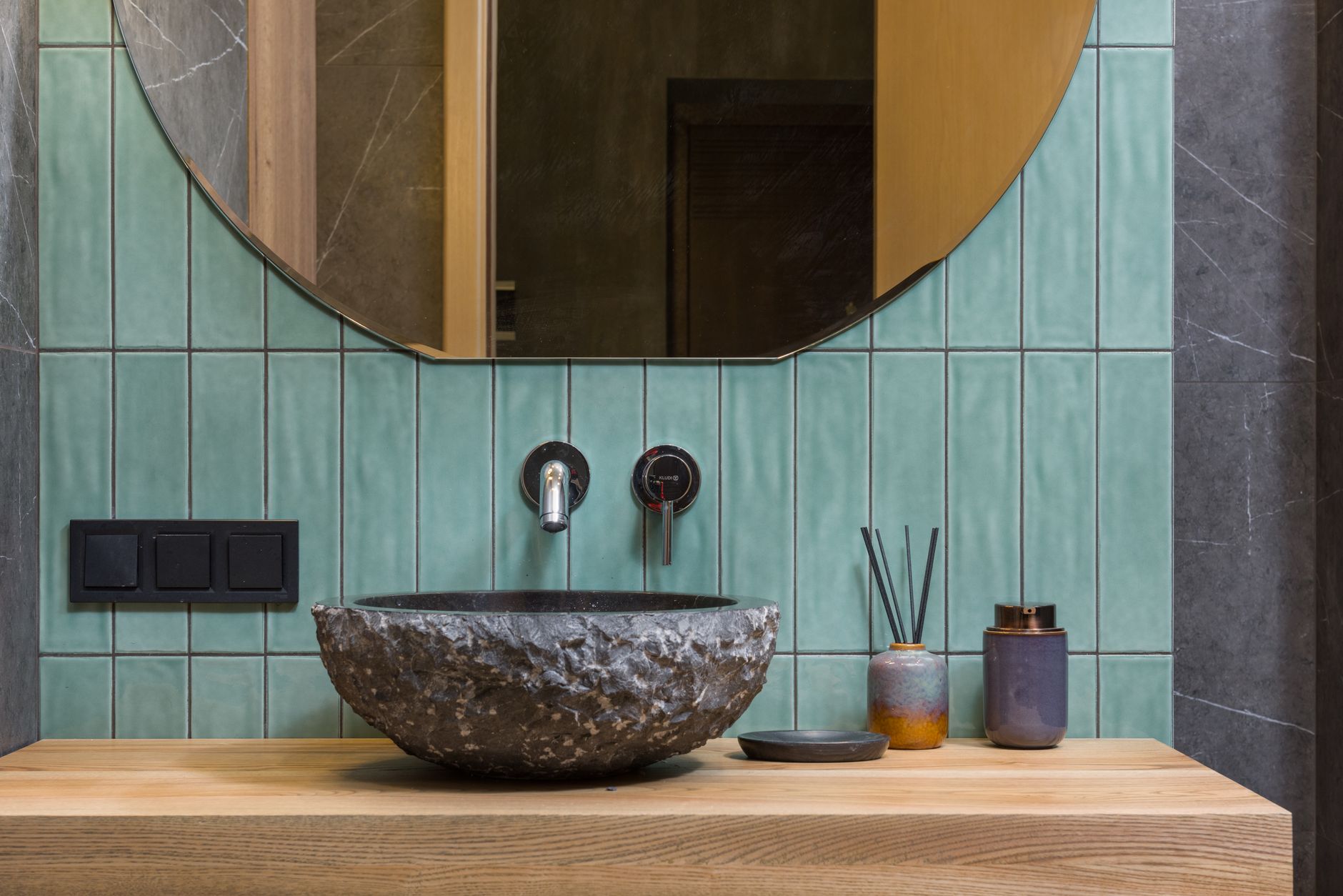 Elegant bathroom featuring a stone washbasin and minimalist design.
