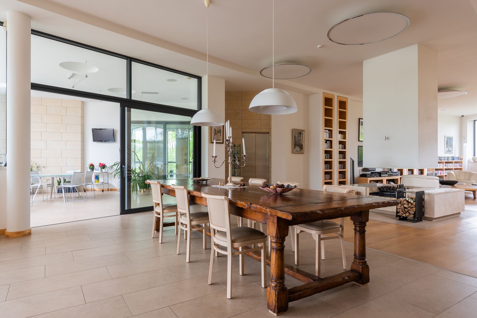 Contemporary dining room with statement lighting fixture above a wooden table