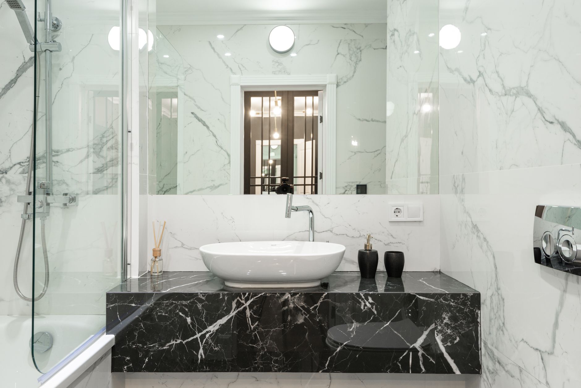 Elegant marble bathroom featuring modern sink and fixtures.