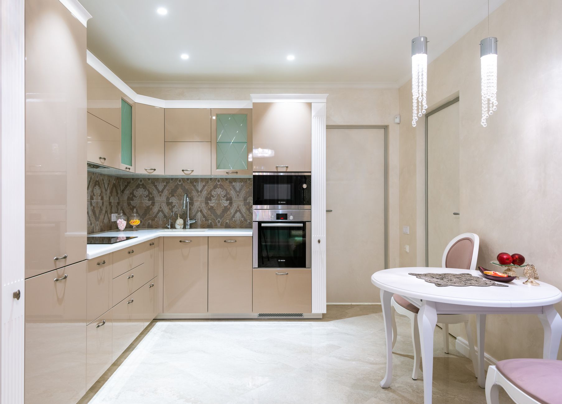 Classic styled round table and chair and minimalist furniture with built in appliances in modern kitchen