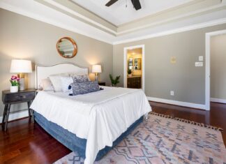 8 Bedroom Rug Ideas That Ground the Whole Room A stylish modern bedroom featuring elegant décor and lighting, perfect for interior design inspiration.