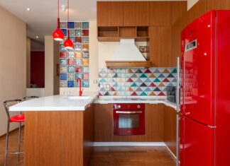 9 Small Space Color Ideas That Make Rooms Feel Bigger Interior of stylish kitchen with bright furniture and colorful tile in modern apartment in daylight