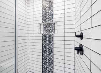 8 Bathroom Tile Ideas That Add Texture and Timeless Style Stylish shower area featuring black and white geometric tiles and contemporary fixtures.
