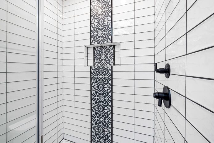pexels-10486084 Stylish shower area featuring black and white geometric tiles and contemporary fixtures.