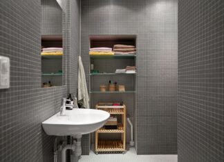 8 Small Bathroom Storage Ideas That Maximize Every Inch A sleek, modern bathroom showcasing minimalist design with functional shelving and clean aesthetics.